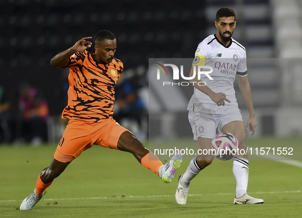 Hasan Khalid Alhaydos (R) of Al-Sadd SC battles for the ball with Khalaf Saad Khalifa (L) of Umm Salal SC during the Ooredoo Qatar Stars Lea...