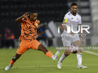 Hasan Khalid Alhaydos (R) of Al-Sadd SC battles for the ball with Khalaf Saad Khalifa (L) of Umm Salal SC during the Ooredoo Qatar Stars Lea...