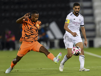 Hasan Khalid Alhaydos (R) of Al-Sadd SC battles for the ball with Khalaf Saad Khalifa (L) of Umm Salal SC during the Ooredoo Qatar Stars Lea...