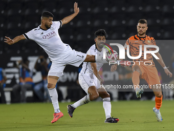 Mohammed Waad Albayati (L) of Al-Sadd SC battles for the ball with Antonio Mance (R) of Umm Salal SC during the Ooredoo Qatar Stars League 2...