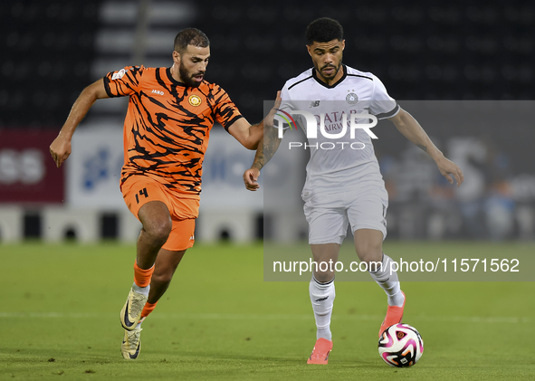 Paulo Silva (R) of Al-Sadd SC and Oussama Tannane (L) of Umm Salal SC are in action during the Ooredoo Qatar Stars League 24/25 match betwee...