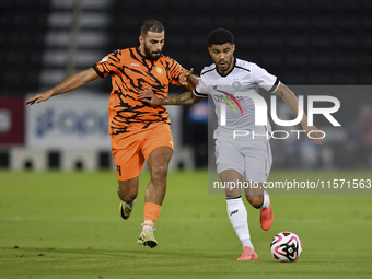 Paulo Silva (R) of Al-Sadd SC and Oussama Tannane (L) of Umm Salal SC are in action during the Ooredoo Qatar Stars League 24/25 match betwee...