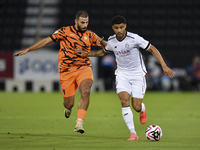 Paulo Silva (R) of Al-Sadd SC and Oussama Tannane (L) of Umm Salal SC are in action during the Ooredoo Qatar Stars League 24/25 match betwee...