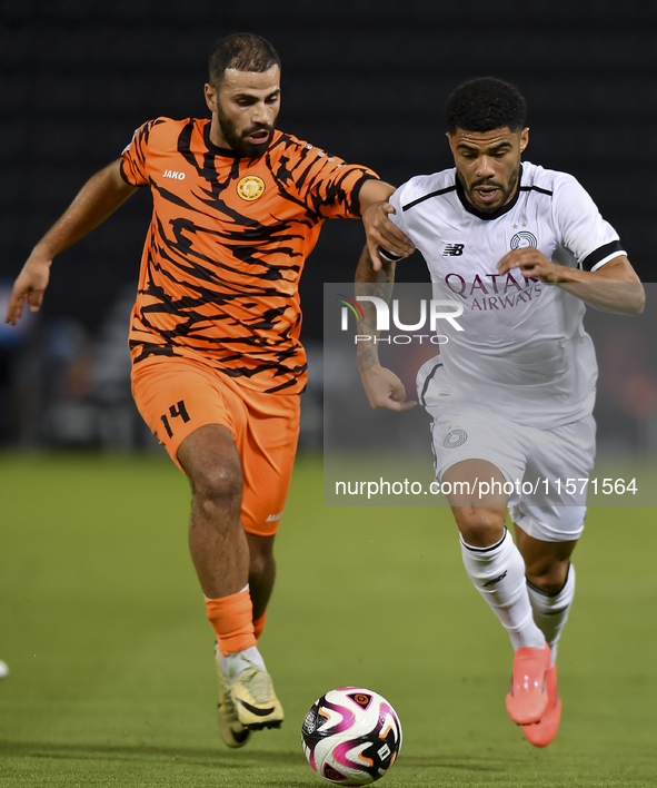 Paulo Silva (R) of Al-Sadd SC and Oussama Tannane (L) of Umm Salal SC are in action during the Ooredoo Qatar Stars League 24/25 match betwee...