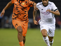 Paulo Silva (R) of Al-Sadd SC and Oussama Tannane (L) of Umm Salal SC are in action during the Ooredoo Qatar Stars League 24/25 match betwee...