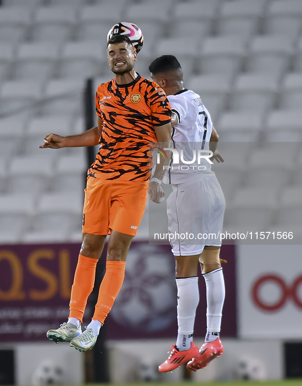 Mohammed Waad Albayati (R) of Al-Sadd SC and Antonio Mance (L) of Umm Salal SC are in action during the Ooredoo Qatar Stars League 24/25 mat...