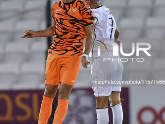 Mohammed Waad Albayati (R) of Al-Sadd SC and Antonio Mance (L) of Umm Salal SC are in action during the Ooredoo Qatar Stars League 24/25 mat...