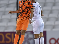 Mohammed Waad Albayati (R) of Al-Sadd SC and Antonio Mance (L) of Umm Salal SC are in action during the Ooredoo Qatar Stars League 24/25 mat...