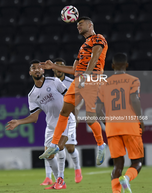 Mohammed Waad Albayati (L) of Al-Sadd SC and Antonio Mance (C) of Umm Salal SC are in action during the Ooredoo Qatar Stars League 24/25 mat...