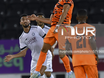 Mohammed Waad Albayati (L) of Al-Sadd SC and Antonio Mance (C) of Umm Salal SC are in action during the Ooredoo Qatar Stars League 24/25 mat...