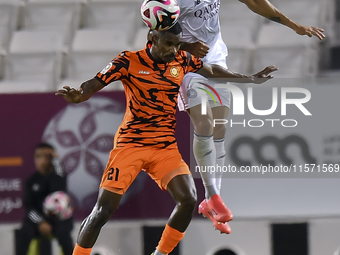 Paulo Silva (R) of Al-Sadd SC and Khalaf Saad Khalifa (L) of Umm Salal SC are in action during the Ooredoo Qatar Stars League 24/25 match be...