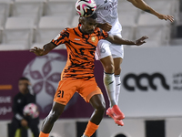 Paulo Silva (R) of Al-Sadd SC and Khalaf Saad Khalifa (L) of Umm Salal SC are in action during the Ooredoo Qatar Stars League 24/25 match be...