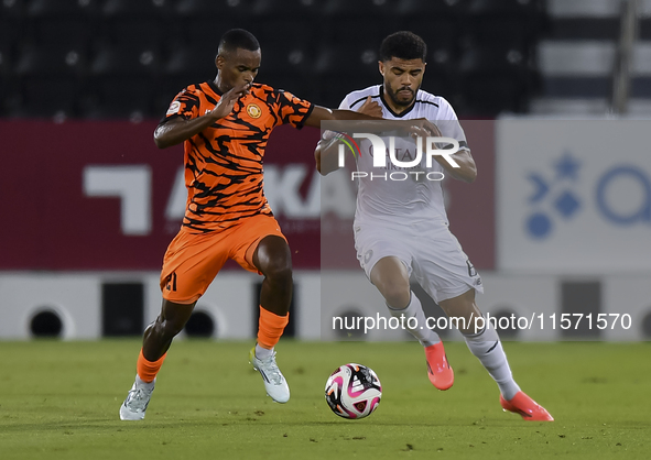 Paulo Silva (R) of Al-Sadd SC and Khalaf Saad Khalifa (L) of Umm Salal SC are in action during the Ooredoo Qatar Stars League 24/25 match be...