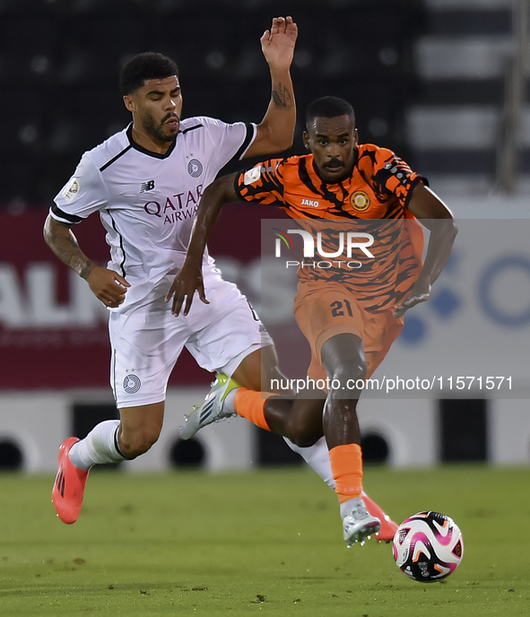 Paulo Silva (L) of Al-Sadd SC and Khalaf Saad Khalifa (R) of Umm Salal SC are in action during the Ooredoo Qatar Stars League 24/25 match be...