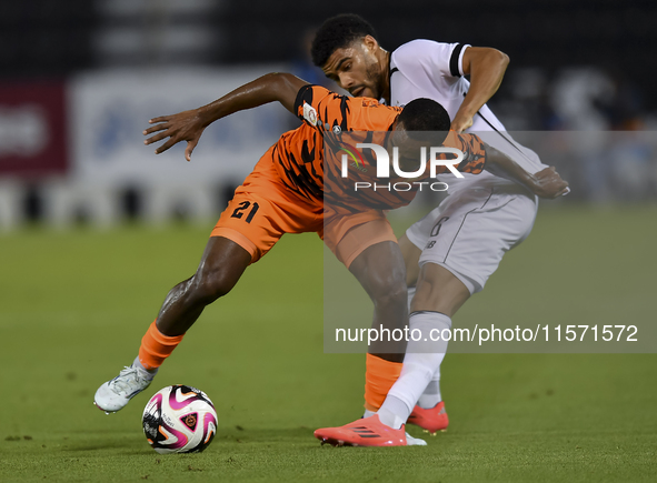 Paulo Silva (R) of Al-Sadd SC and Khalaf Saad Khalifa (L) of Umm Salal SC are in action during the Ooredoo Qatar Stars League 24/25 match be...