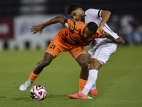 Paulo Silva (R) of Al-Sadd SC and Khalaf Saad Khalifa (L) of Umm Salal SC are in action during the Ooredoo Qatar Stars League 24/25 match be...