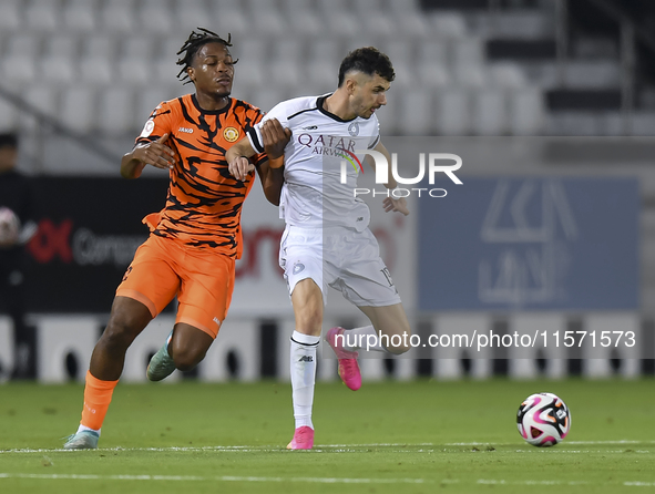 Rafael Sebastian Mujica Garcia (R) of Al-Sadd SC and Edidiong Nigerian (L) of Umm Salal SC are in action during the Ooredoo Qatar Stars Leag...