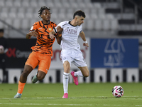 Rafael Sebastian Mujica Garcia (R) of Al-Sadd SC and Edidiong Nigerian (L) of Umm Salal SC are in action during the Ooredoo Qatar Stars Leag...