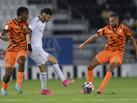 Rafael Sebastian Mujica Garcia (C) of Al-Sadd SC and Edidiong Nigerian (L) of Umm Salal SC are in action during the Ooredoo Qatar Stars Leag...