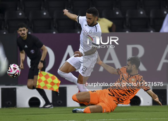 Giovani Henrique of Al-Sadd SC and Marouane Louadni of Umm Salal SC are in action during the Ooredoo Qatar Stars League 24/25 match between...