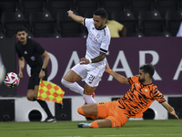 Giovani Henrique of Al-Sadd SC and Marouane Louadni of Umm Salal SC are in action during the Ooredoo Qatar Stars League 24/25 match between...