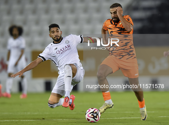 Mohammed Waad Albayati (L) of Al-Sadd SC battles for the ball with Oussama Tannane (R) of Umm Salal SC during the Ooredoo Qatar Stars League...