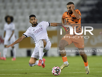 Mohammed Waad Albayati (L) of Al-Sadd SC battles for the ball with Oussama Tannane (R) of Umm Salal SC during the Ooredoo Qatar Stars League...