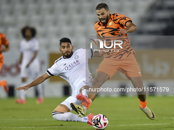 Mohammed Waad Albayati (L) of Al-Sadd SC battles for the ball with Oussama Tannane (R) of Umm Salal SC during the Ooredoo Qatar Stars League...