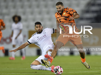 Mohammed Waad Albayati (L) of Al-Sadd SC battles for the ball with Oussama Tannane (R) of Umm Salal SC during the Ooredoo Qatar Stars League...