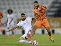 Mohammed Waad Albayati (L) of Al-Sadd SC battles for the ball with Oussama Tannane (R) of Umm Salal SC during the Ooredoo Qatar Stars League...