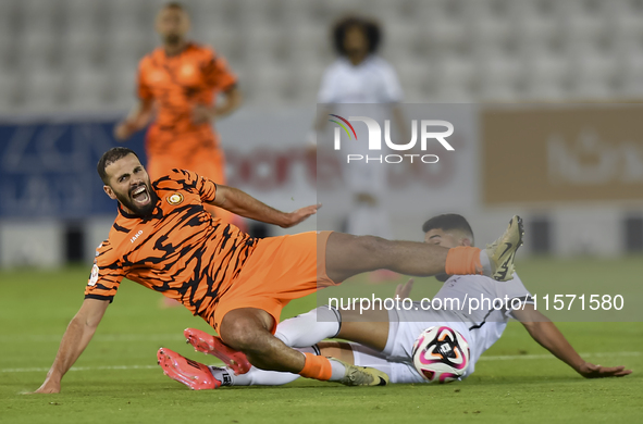 Mohammed Waad Albayati (R) of Al-Sadd SC battles for the ball with Oussama Tannane (L) of Umm Salal SC during the Ooredoo Qatar Stars League...