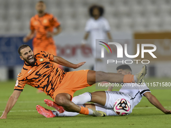 Mohammed Waad Albayati (R) of Al-Sadd SC battles for the ball with Oussama Tannane (L) of Umm Salal SC during the Ooredoo Qatar Stars League...