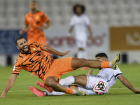 Mohammed Waad Albayati (R) of Al-Sadd SC battles for the ball with Oussama Tannane (L) of Umm Salal SC during the Ooredoo Qatar Stars League...