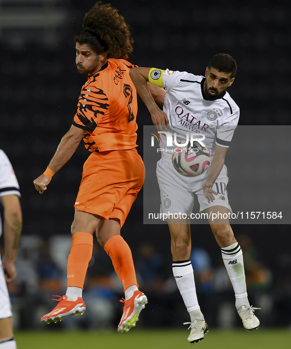 Hasan Khalid Alhaydos (R) of Al-Sadd SC battles for the ball with Omar Yahya Rabah (L) of Umm Salal SC during the Ooredoo Qatar Stars League...