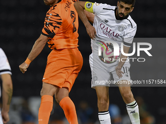 Hasan Khalid Alhaydos (R) of Al-Sadd SC battles for the ball with Omar Yahya Rabah (L) of Umm Salal SC during the Ooredoo Qatar Stars League...