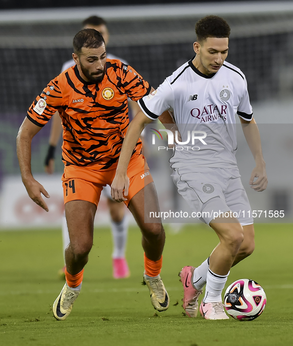 Moustafa Tarek Mashal (R) of Al-Sadd SC battles for the ball with Oussama Tannane (L) of Umm Salal SC during the Ooredoo Qatar Stars League...