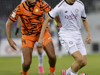 Moustafa Tarek Mashal (R) of Al-Sadd SC battles for the ball with Oussama Tannane (L) of Umm Salal SC during the Ooredoo Qatar Stars League...