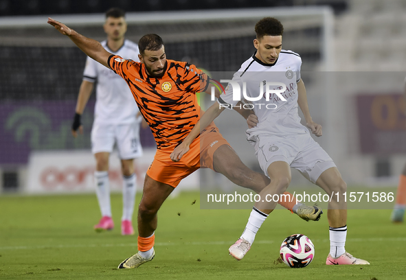 Moustafa Tarek Mashal (R) of Al-Sadd SC battles for the ball with Oussama Tannane (L) of Umm Salal SC during the Ooredoo Qatar Stars League...