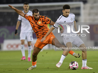 Moustafa Tarek Mashal (R) of Al-Sadd SC battles for the ball with Oussama Tannane (L) of Umm Salal SC during the Ooredoo Qatar Stars League...