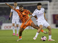 Moustafa Tarek Mashal (R) of Al-Sadd SC battles for the ball with Oussama Tannane (L) of Umm Salal SC during the Ooredoo Qatar Stars League...