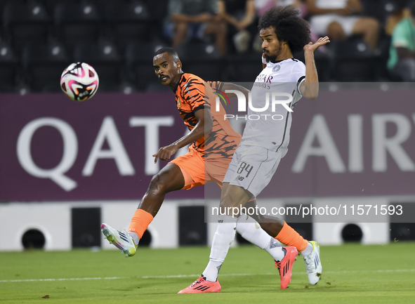 Akram Hassan Afif of Al-Sadd SC battles for the ball with Khalaf Saad Khalifa of Umm Salal SC during the Ooredoo Qatar Stars League 24/25 ma...