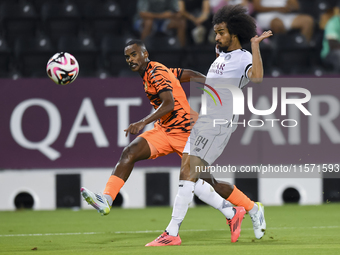 Akram Hassan Afif of Al-Sadd SC battles for the ball with Khalaf Saad Khalifa of Umm Salal SC during the Ooredoo Qatar Stars League 24/25 ma...