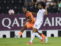 Akram Hassan Afif of Al-Sadd SC battles for the ball with Khalaf Saad Khalifa of Umm Salal SC during the Ooredoo Qatar Stars League 24/25 ma...