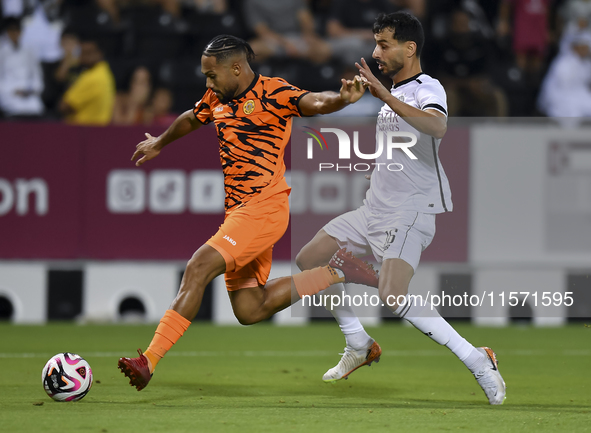 Boualem Khoukhi (R) of Al-Sadd SC battles for the ball with Kenji Joel (L) of Umm Salal SC during the Ooredoo Qatar Stars League 24/25 match...