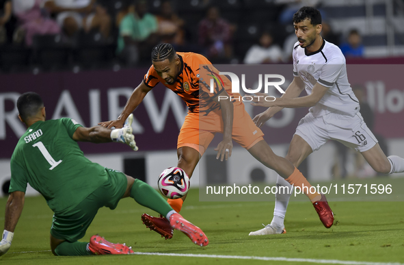 Boualem Khoukhi (R) of Al-Sadd SC battles for the ball with Kenji Joel (C) of Umm Salal SC during the Ooredoo Qatar Stars League 24/25 match...