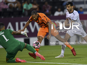 Boualem Khoukhi (R) of Al-Sadd SC battles for the ball with Kenji Joel (C) of Umm Salal SC during the Ooredoo Qatar Stars League 24/25 match...