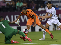 Boualem Khoukhi (R) of Al-Sadd SC battles for the ball with Kenji Joel (C) of Umm Salal SC during the Ooredoo Qatar Stars League 24/25 match...