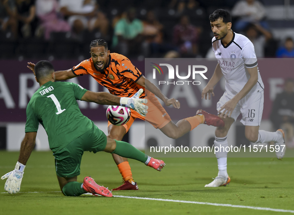 Boualem Khoukhi (R) of Al-Sadd SC battles for the ball with Kenji Joel (C) of Umm Salal SC during the Ooredoo Qatar Stars League 24/25 match...