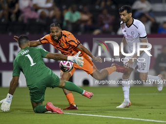 Boualem Khoukhi (R) of Al-Sadd SC battles for the ball with Kenji Joel (C) of Umm Salal SC during the Ooredoo Qatar Stars League 24/25 match...