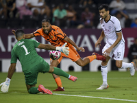 Boualem Khoukhi (R) of Al-Sadd SC battles for the ball with Kenji Joel (C) of Umm Salal SC during the Ooredoo Qatar Stars League 24/25 match...